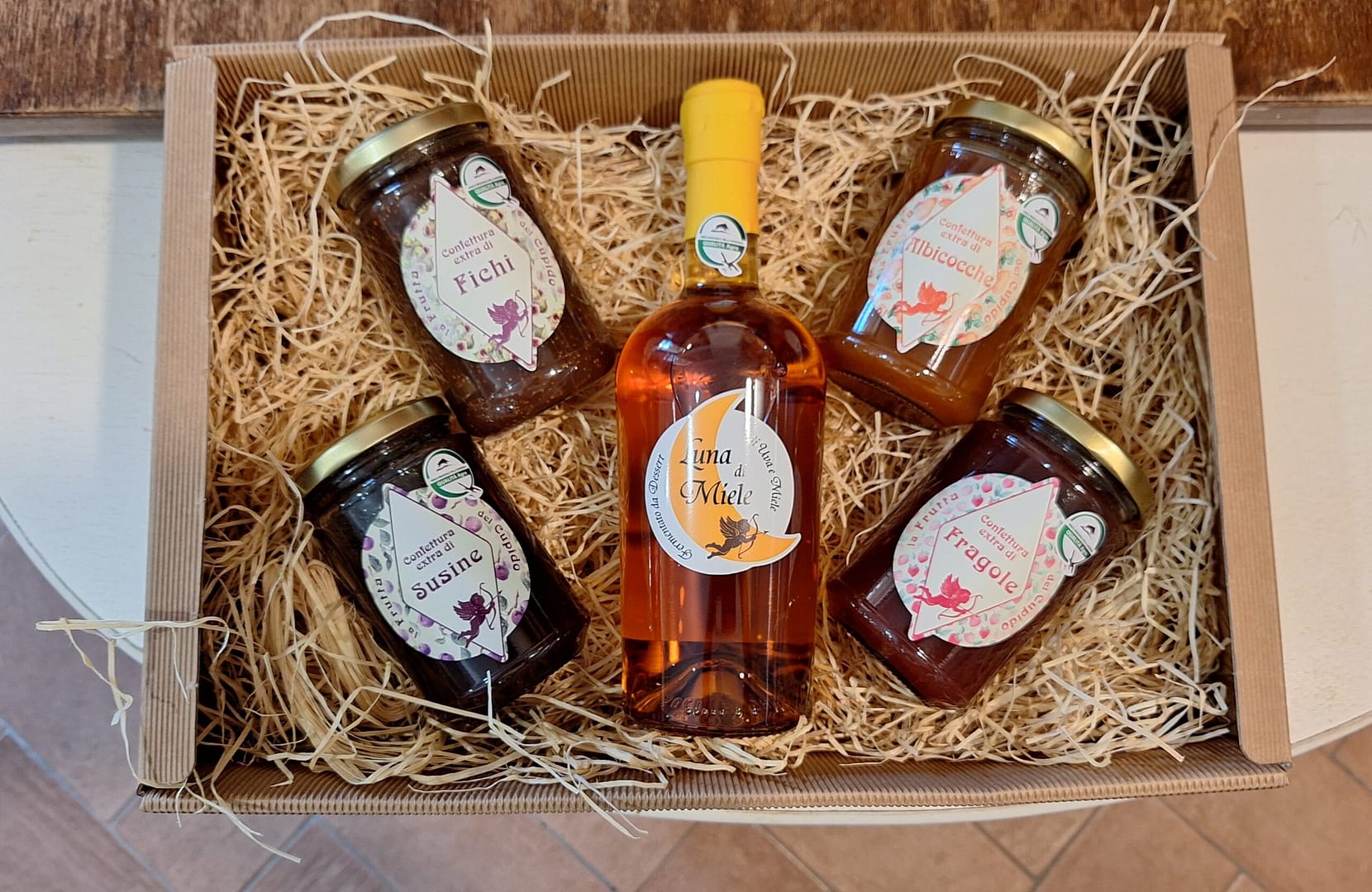 Cesto natalizio artigianale: confetture di fichi, susine, albicocche, fragole e miele Luna di Miele. Idea regalo gourmet.